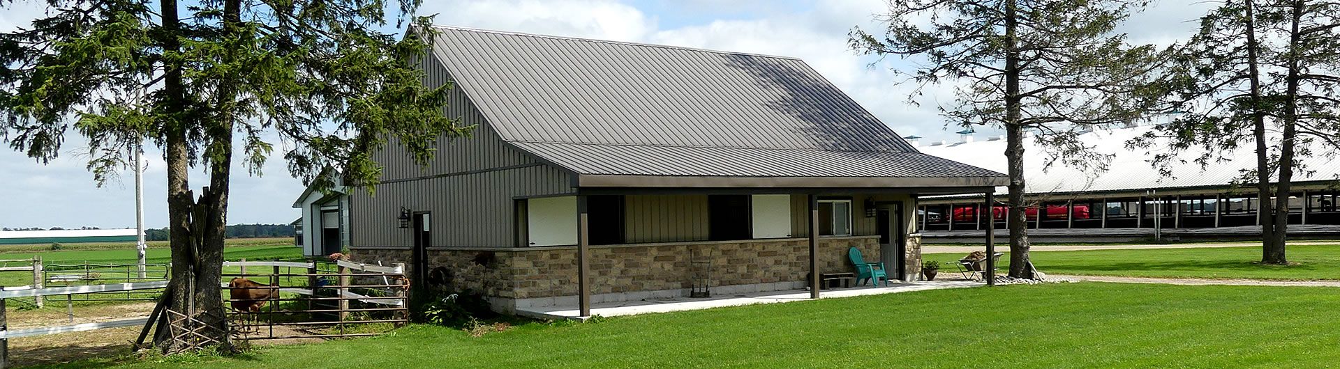 small farm house with out buildings behind